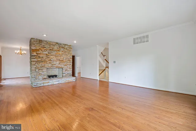 a kitchen with stainless steel appliances granite countertop a refrigerator a sink dishwasher a stove with wooden floor and cabinets