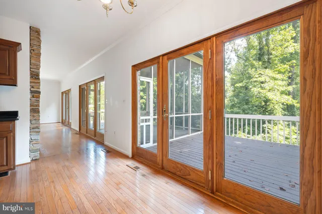 a open kitchen with stainless steel appliances granite countertop a refrigerator a sink dishwasher and a stove with wooden floor