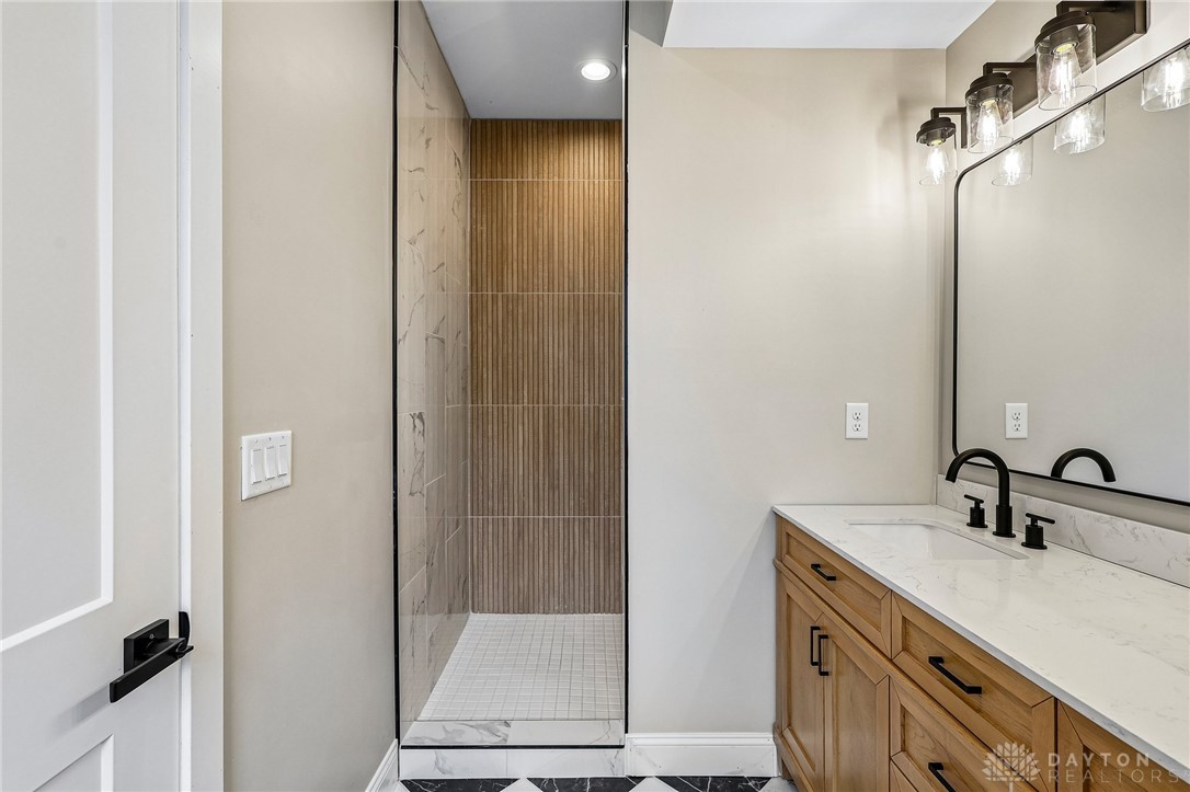 3906 Edwards Road, Unit C Cincinnati, OH 45209 - Photo 30 of 46 This modern bathroom features a stylish vanity and a spacious, well-lit shower area.