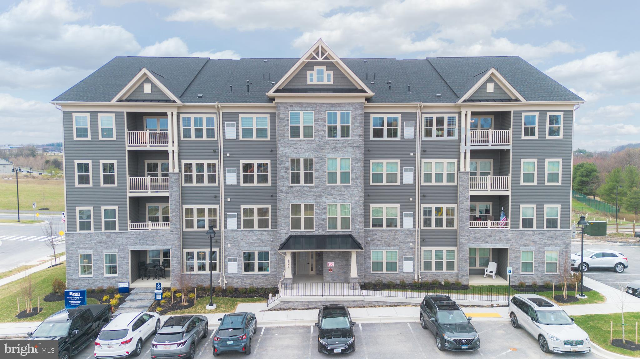 a front view of a building with glass windows and a fountain