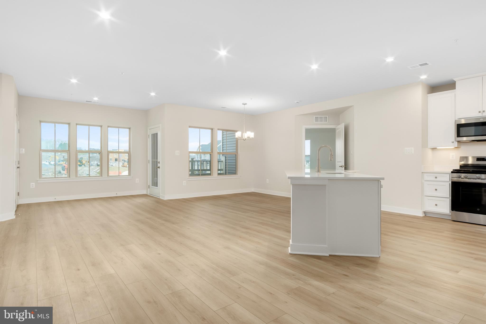 9935 Sofield Place, Unit 201 Frederick, MD 21701 - Photo 23 of 39 a view of an empty room with a window and wooden floor