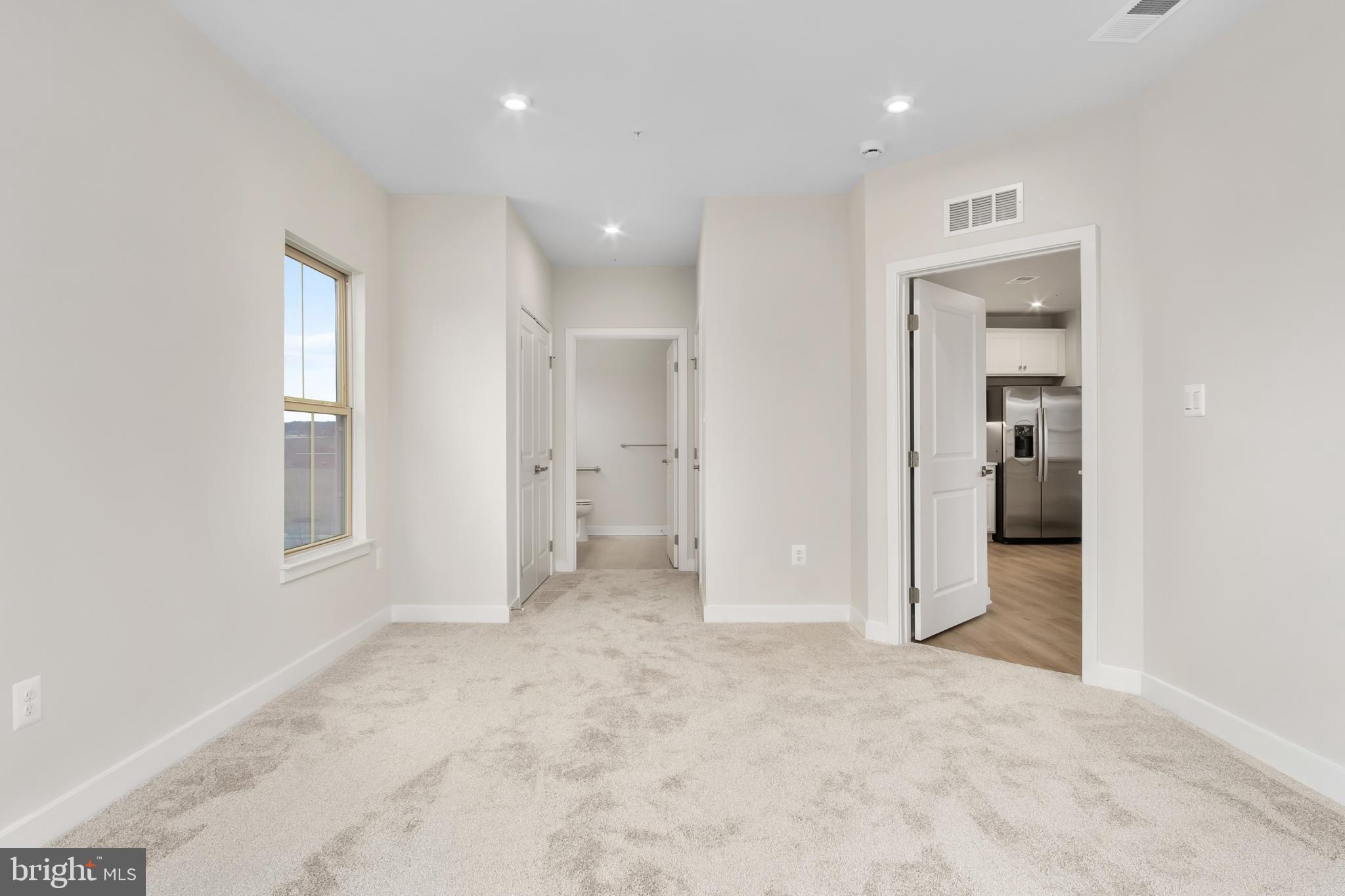 9935 Sofield Place, Unit 201 Frederick, MD 21701 - Photo 25 of 39 an empty room with a bathroom and a bathroom