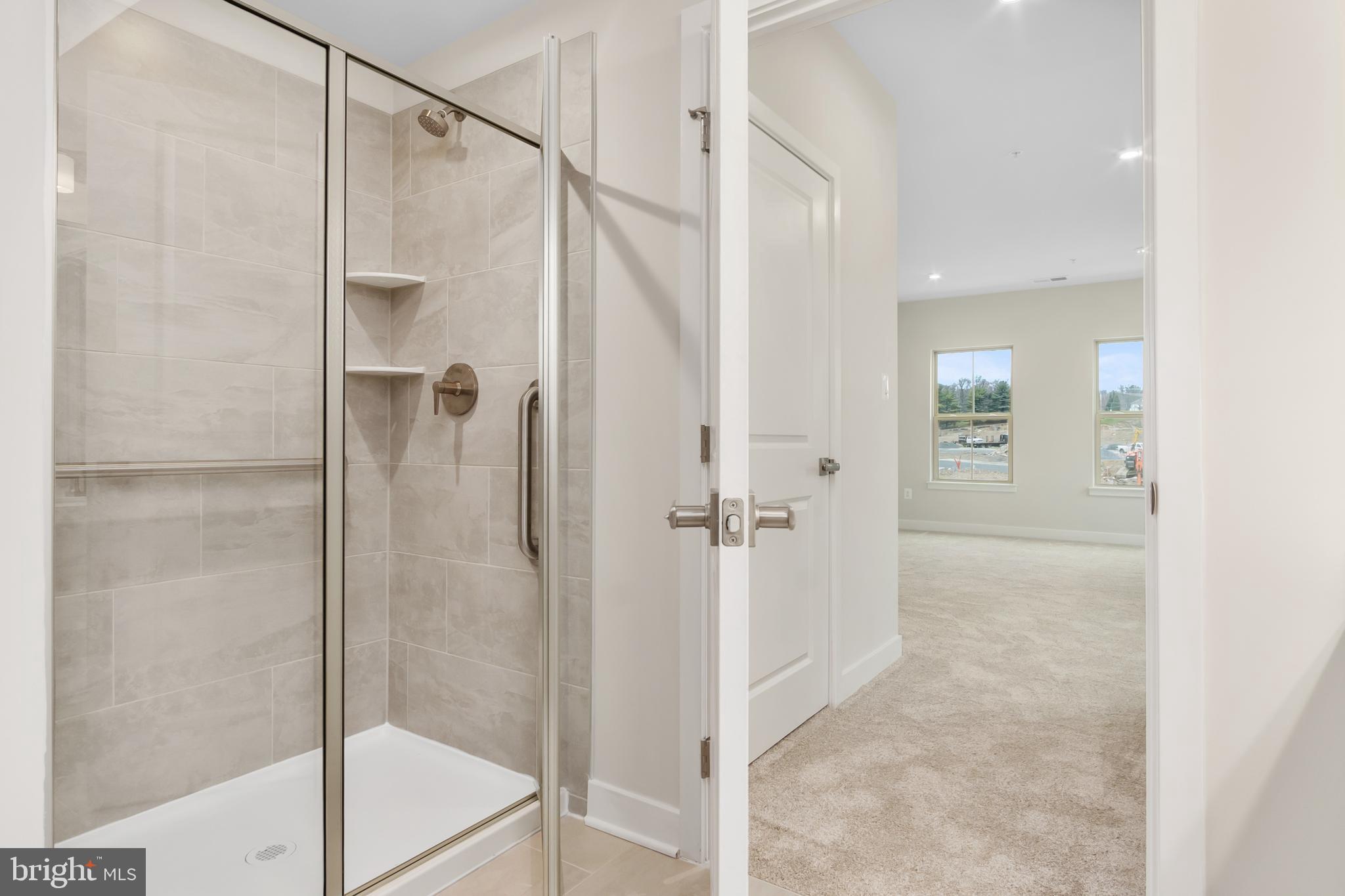 9935 Sofield Place, Unit 201 Frederick, MD 21701 - Photo 28 of 39 a bathroom with a glass shower door
