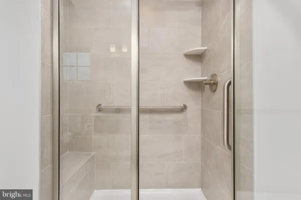 a bathroom with a glass shower door