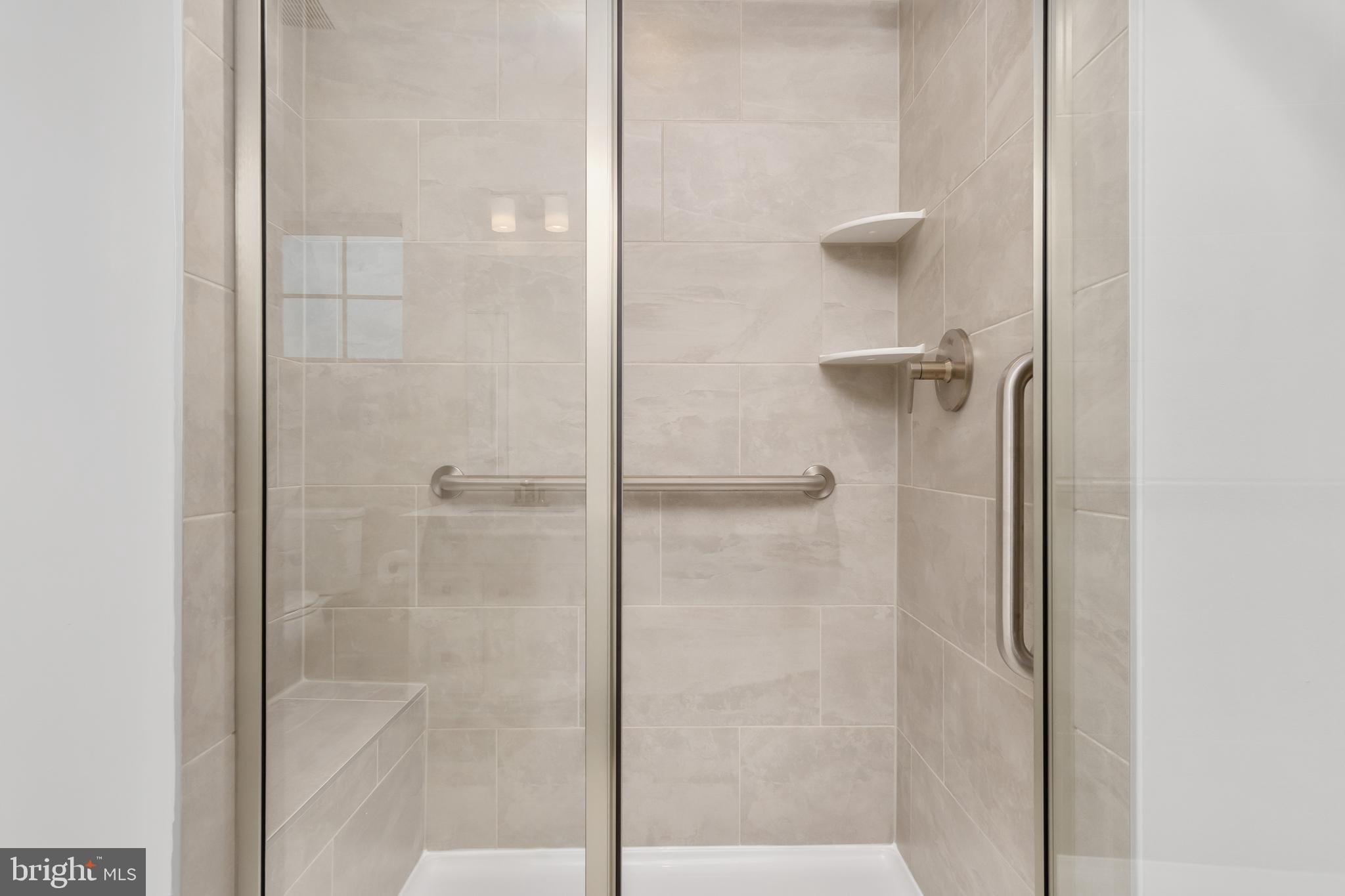 9935 Sofield Place, Unit 201 Frederick, MD 21701 - Photo 29 of 39 a bathroom with a glass shower door