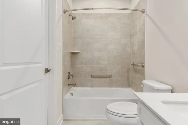 a bathroom with a toilet and a bath tub
