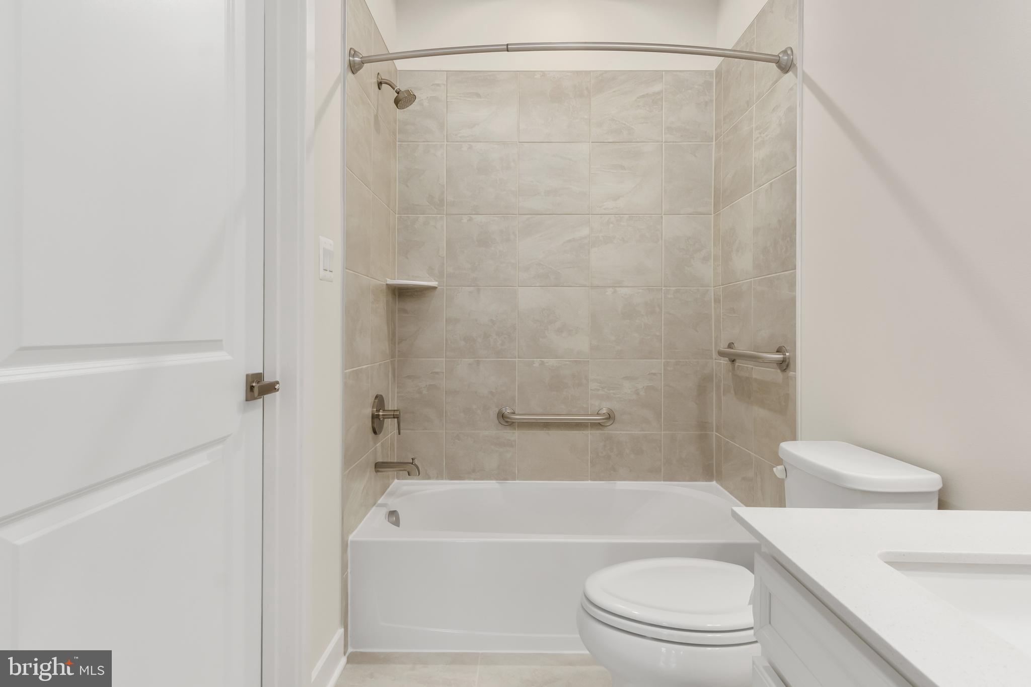 9935 Sofield Place, Unit 201 Frederick, MD 21701 - Photo 33 of 39 a bathroom with a toilet and a bath tub