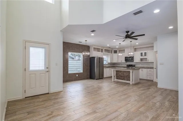 a view of kitchen with sink and refrigerator