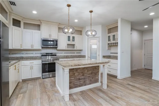 a kitchen with stainless steel appliances granite countertop a stove and a sink