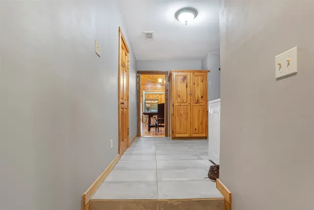 a bedroom with a bed and a dresser next to a window
