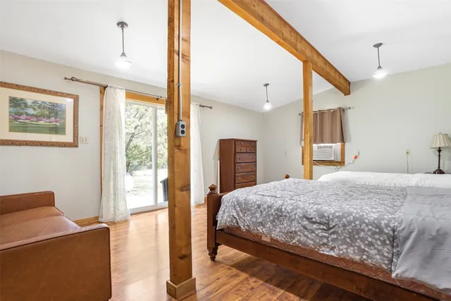 a spacious bedroom with two beds and painted walls