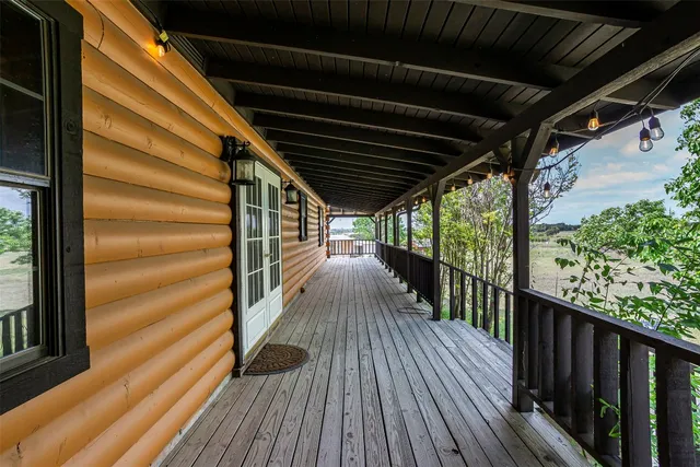 a view of porch with green trees in front
