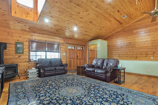 a living room with furniture a pool table and chairs