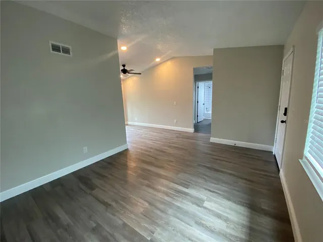 wooden floor in an empty room with a window