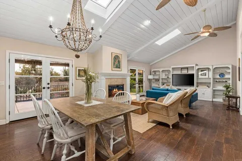 a view of a dining room with furniture wooden floor and chandelier