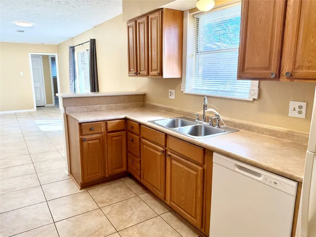 a bathroom with a granite countertop sink a mirror and a shower