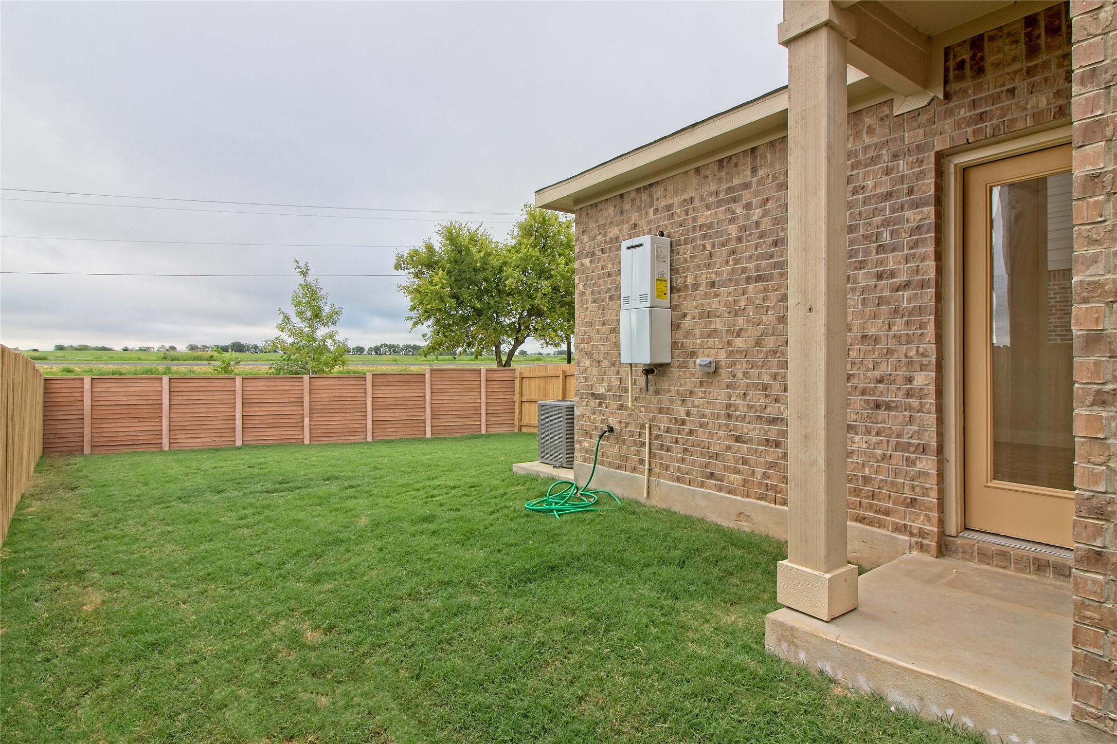 555 White Steppe Way Georgetown, TX 78626 - Photo 27 of 40 a view of a backyard with brick wall