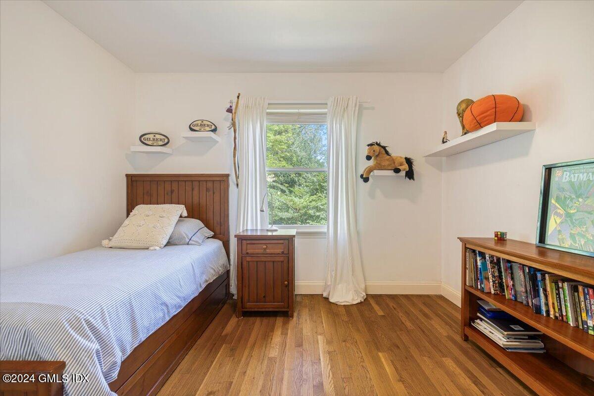 70 Gregory Road Cos Cob, CT 06807 - Photo 19 of 39 a bedroom with a bed and wooden floor