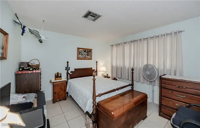 a bed room with a bed and a chair