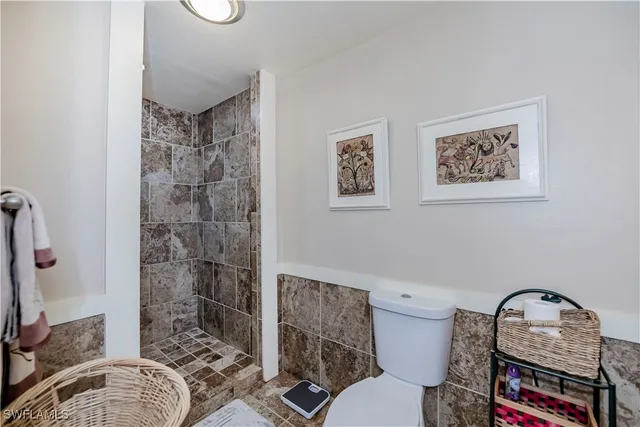 a bathroom with a toilet a sink and a shower