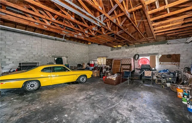 a view of swimming pool with chairs and a barbeque