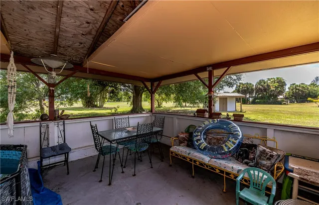 a view of a patio with a table chairs and a backyard