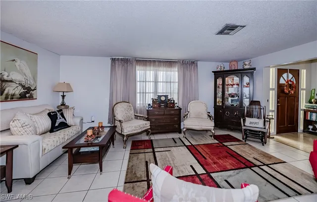 a living room with furniture a rug and a window