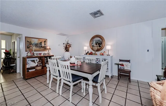 a dining room with furniture and a window