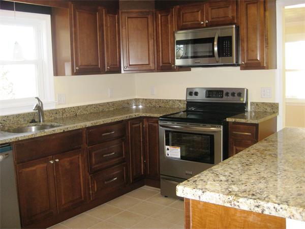 10 Silvermine Road Woburn, MA 01801 - Photo 7 of 14 a kitchen with granite countertop cabinets stainless steel appliances and a sink