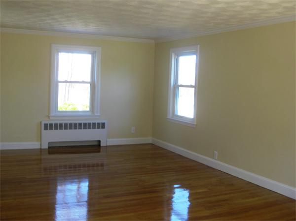 10 Silvermine Road Woburn, MA 01801 - Photo 10 of 14 a view of an empty room with wooden floor and a window
