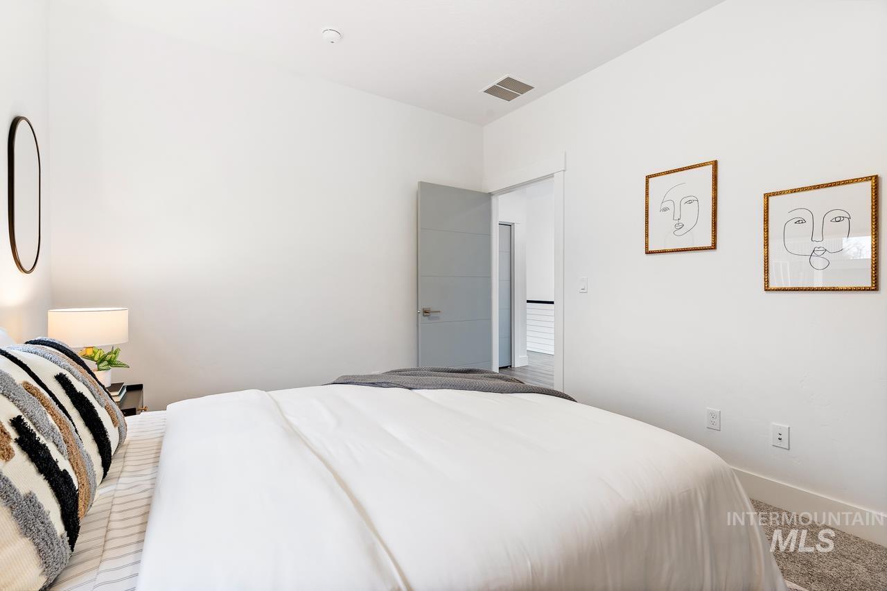 599 West Warren Street Boise, ID 83706 - Photo 36 of 41 Bedroom featuring white walls, light gray carpeting, and a built-in recessed ceiling light