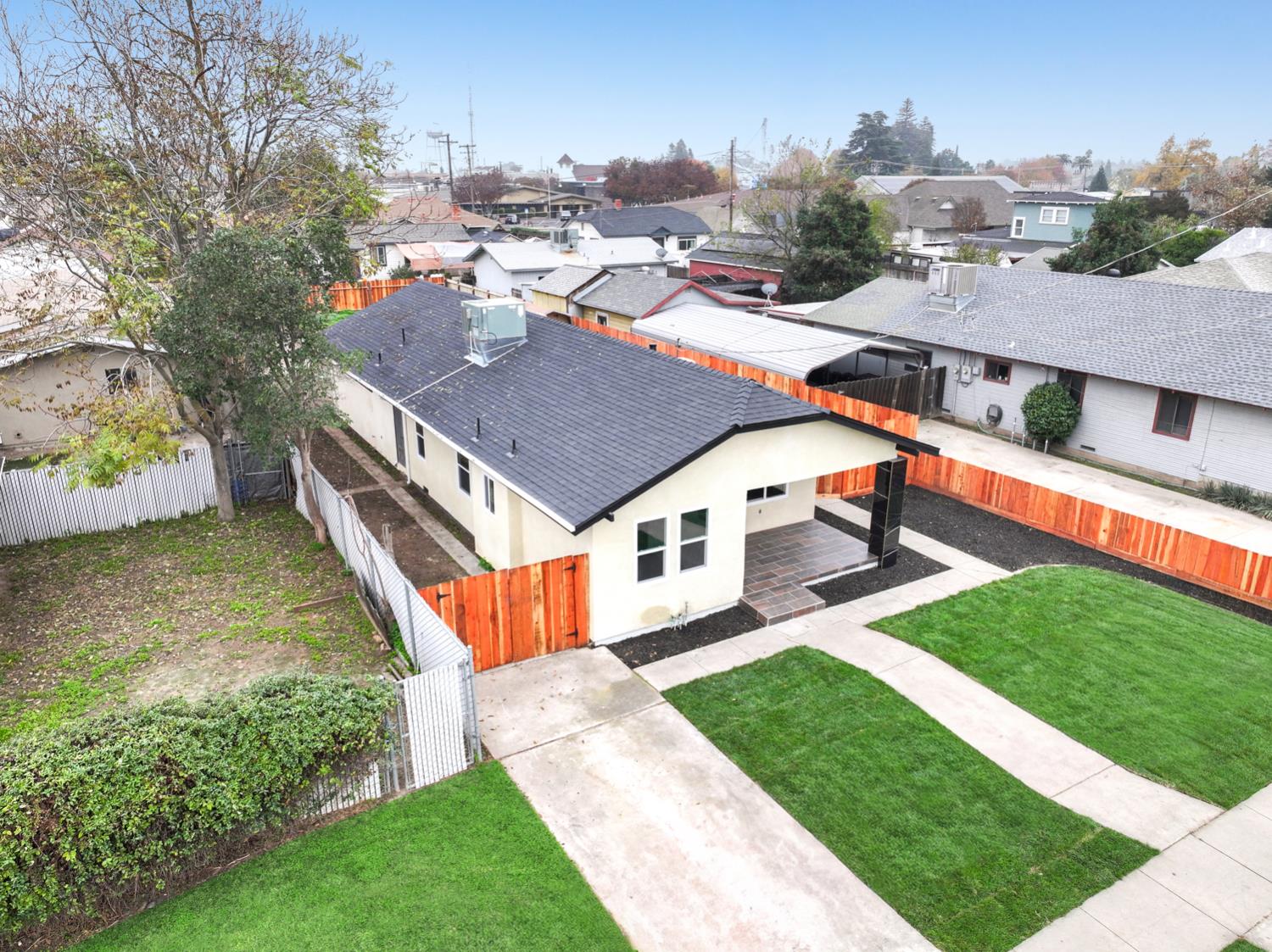 136 North Acacia Avenue Ripon, CA 95366 - Photo 5 of 21 an aerial view of a house with swimming pool garden and tall trees