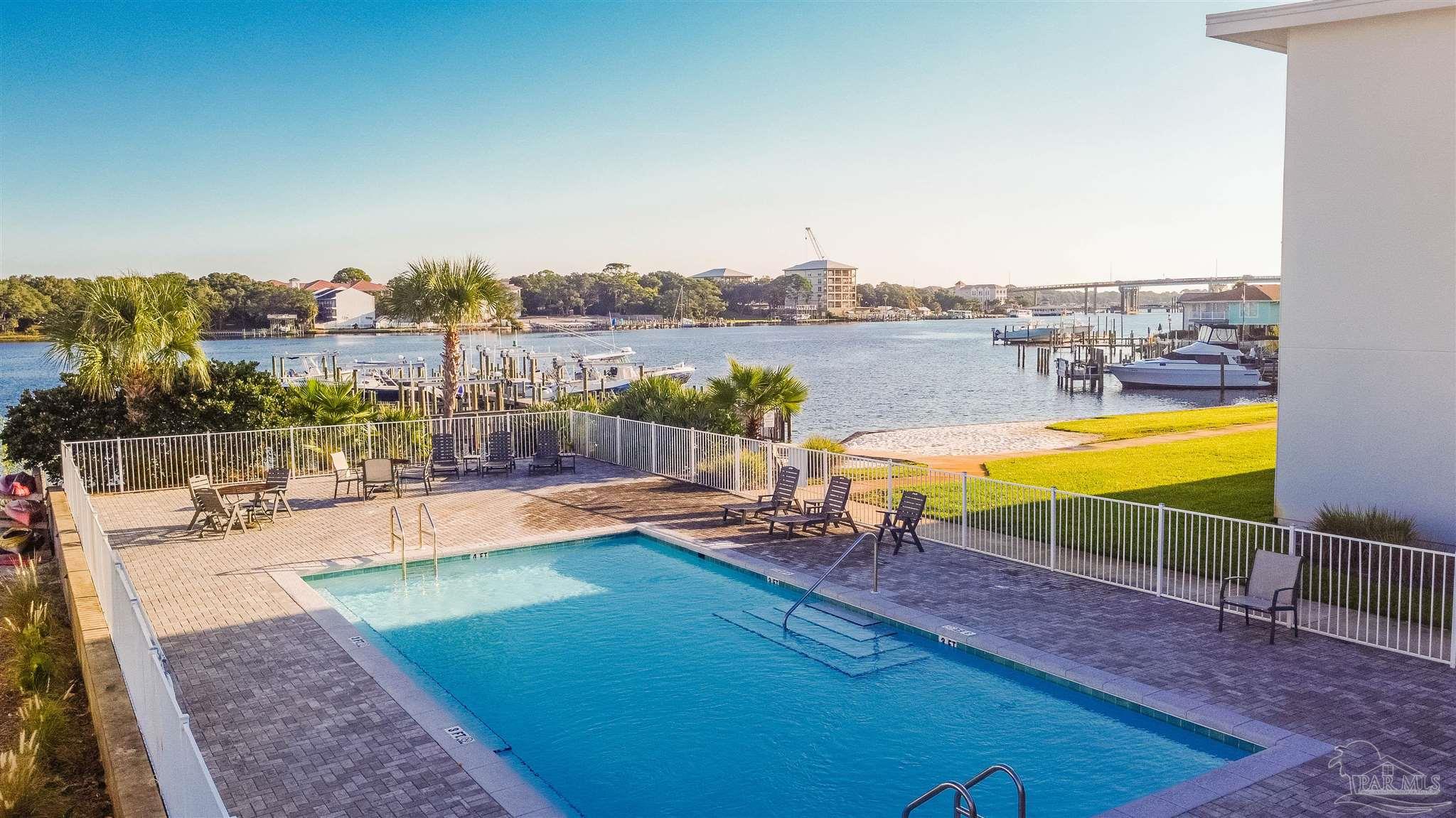 340 Bluefish Drive, Unit 206 Fort Walton Beach, FL 32548 - Photo 13 of 43 a view of a swimming pool with lounge chairs