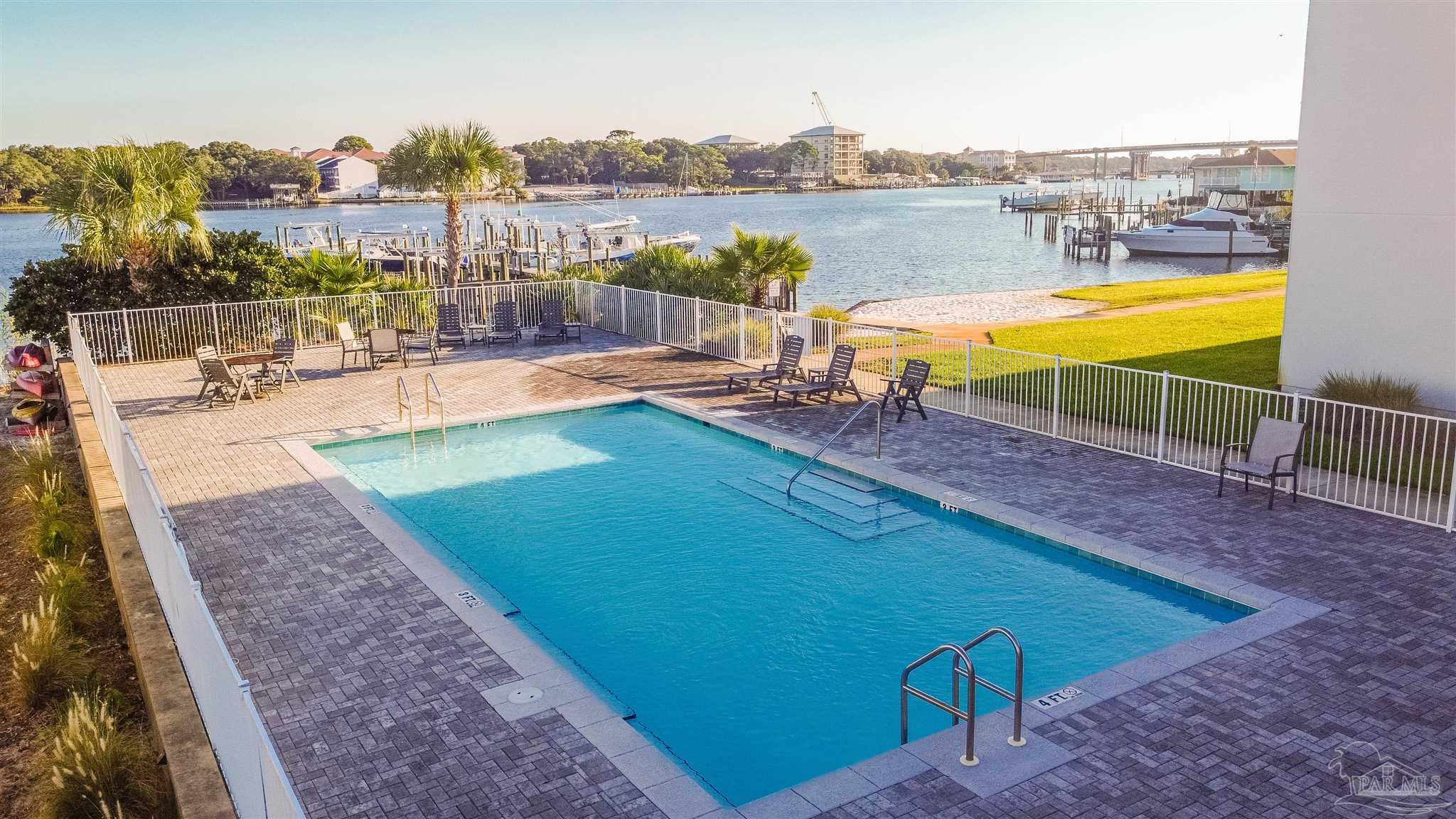 340 Bluefish Drive, Unit 206 Fort Walton Beach, FL 32548 - Photo 14 of 43 swimming pool with outdoor seating and plants
