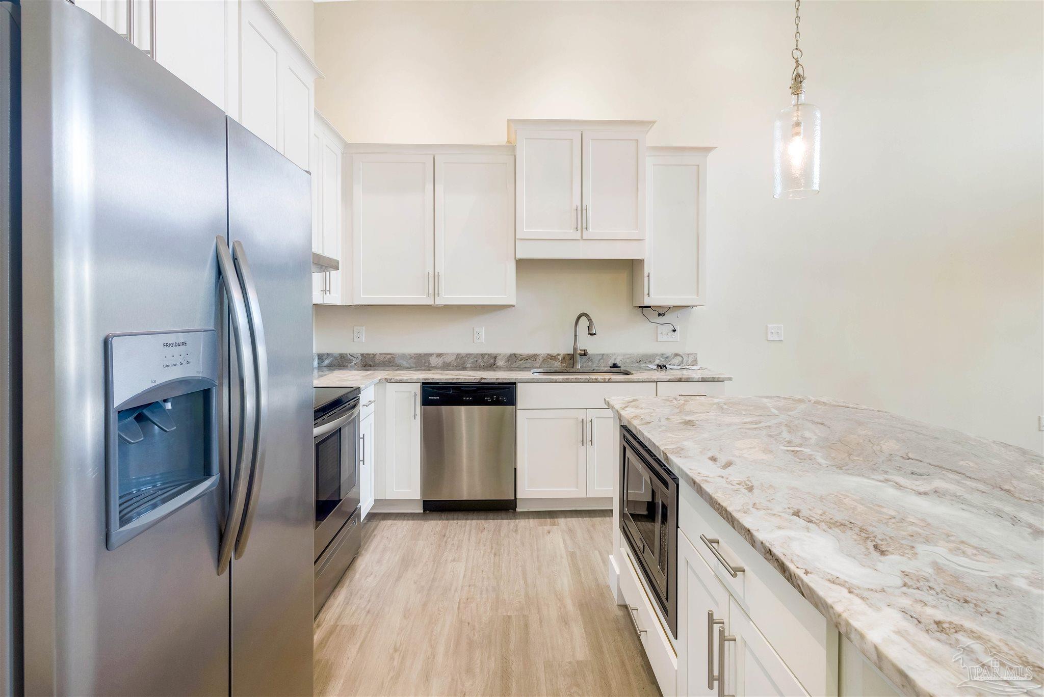 340 Bluefish Drive, Unit 206 Fort Walton Beach, FL 32548 - Photo 20 of 43 a kitchen with a sink stove and refrigerator