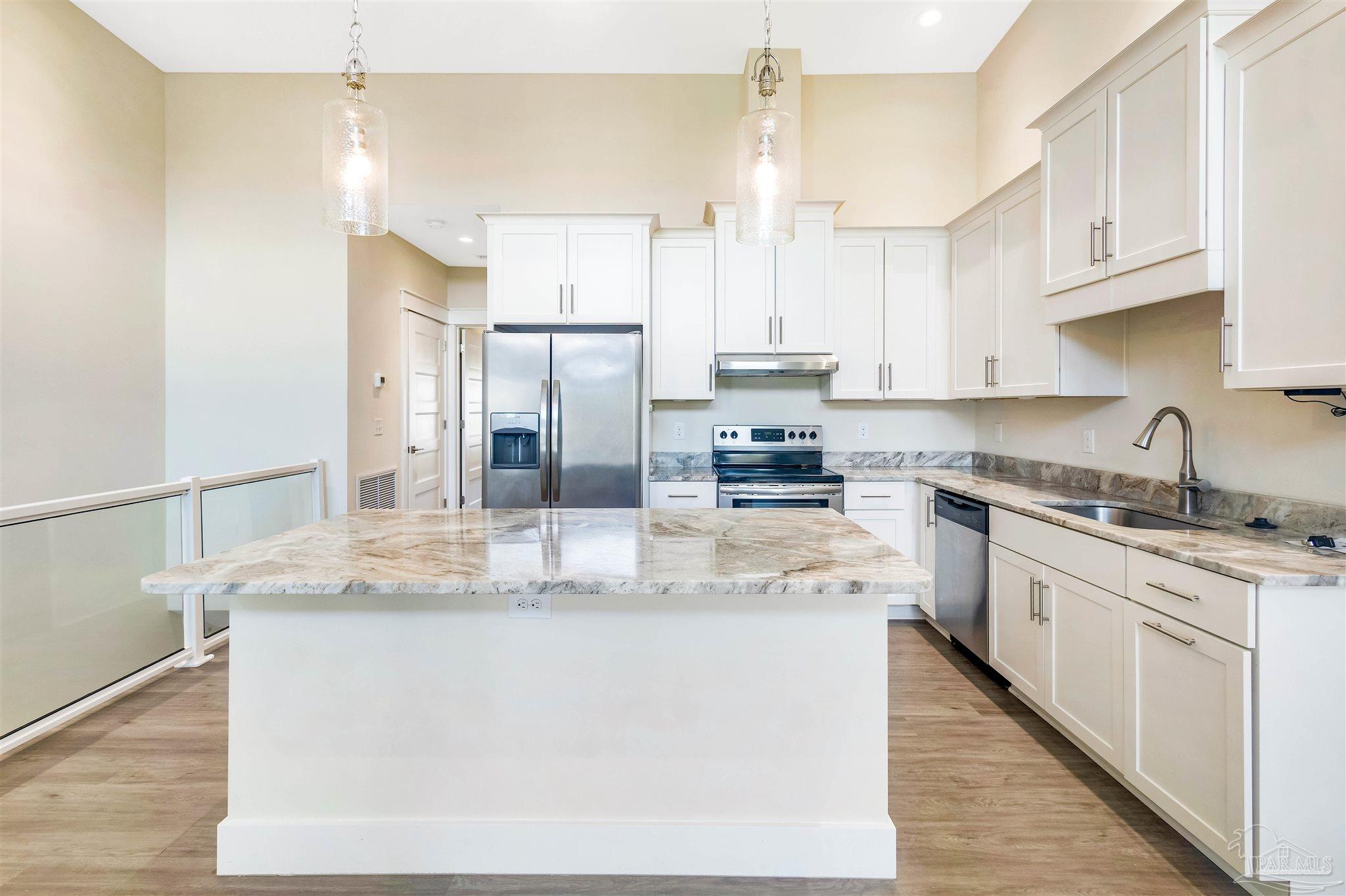 340 Bluefish Drive, Unit 206 Fort Walton Beach, FL 32548 - Photo 21 of 43 a kitchen with stainless steel appliances granite countertop a sink stove and refrigerator