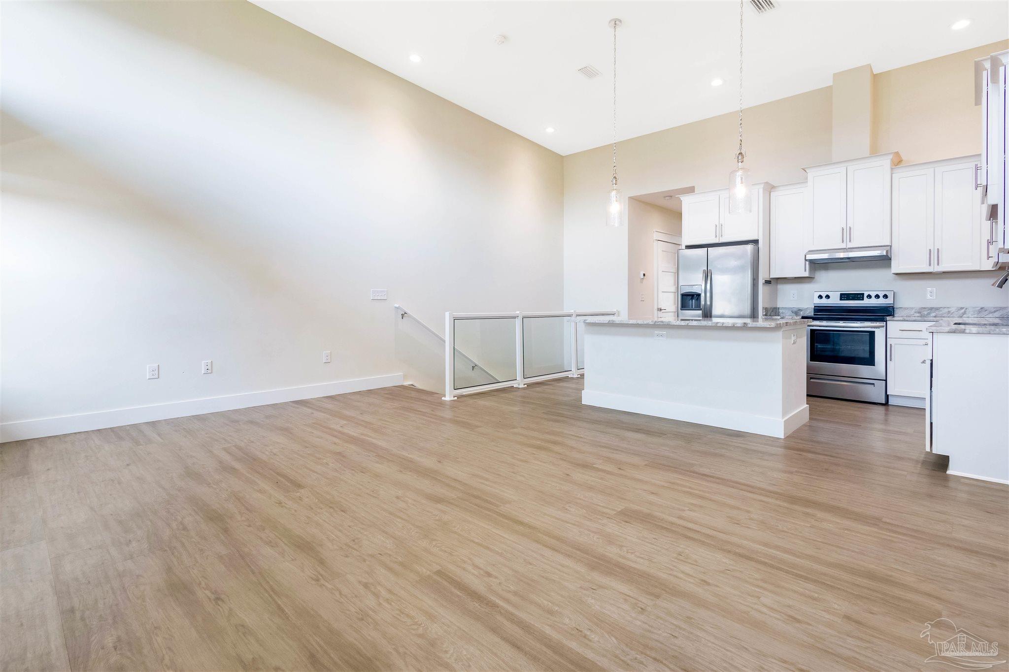 340 Bluefish Drive, Unit 206 Fort Walton Beach, FL 32548 - Photo 23 of 43 a view of a kitchen with wooden floor