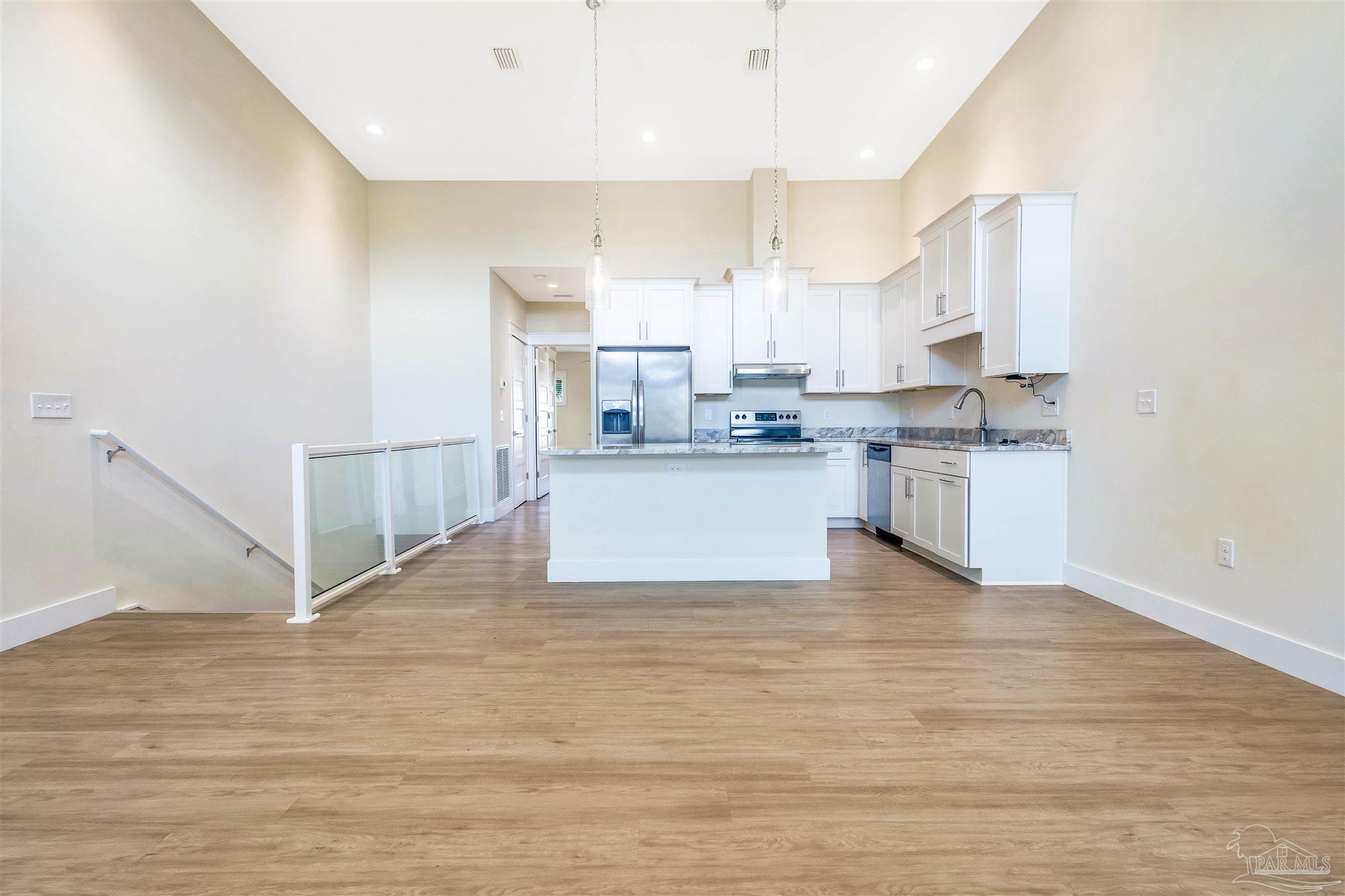 340 Bluefish Drive, Unit 206 Fort Walton Beach, FL 32548 - Photo 24 of 43 a kitchen with stainless steel appliances a stove top oven a sink and white cabinets