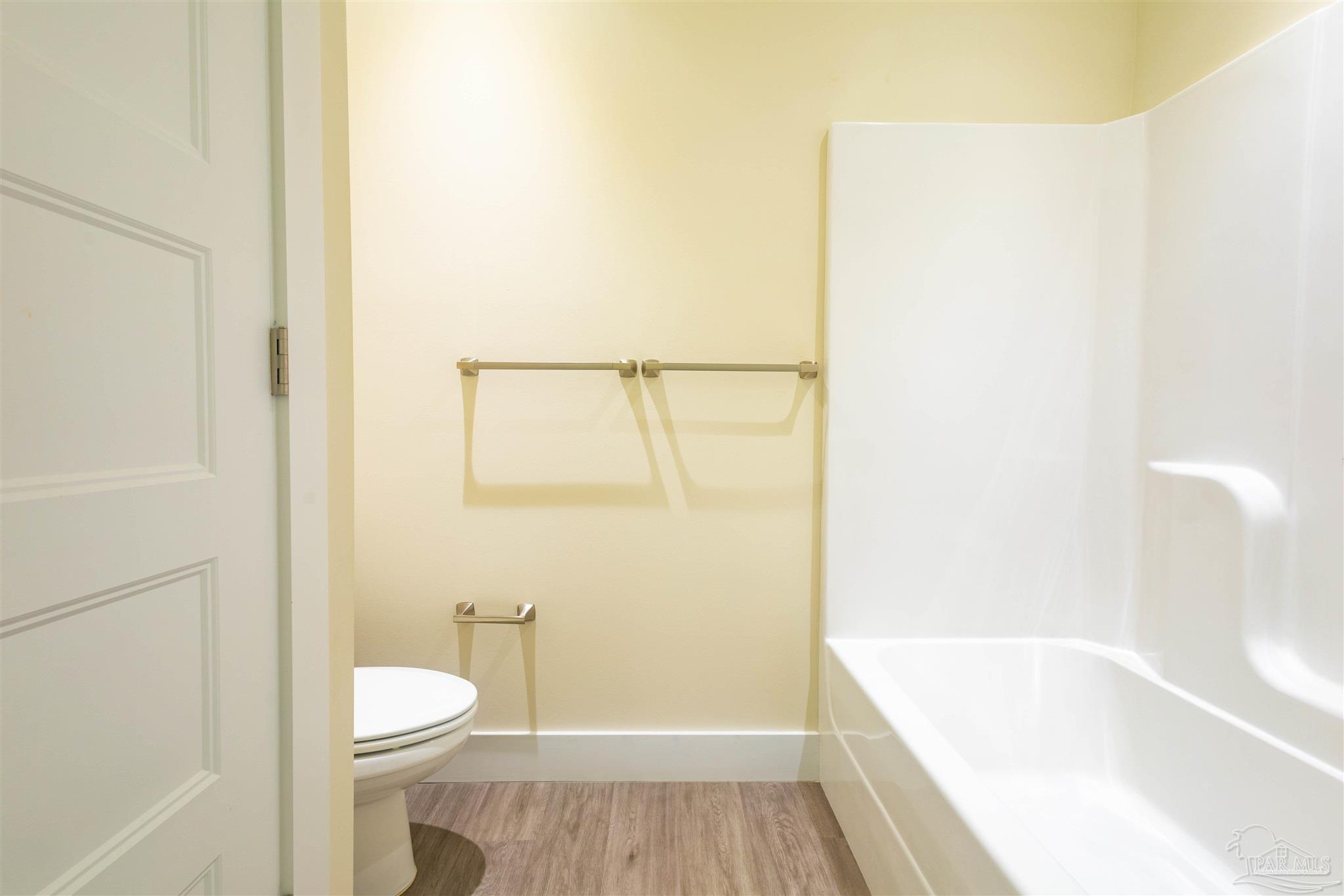 340 Bluefish Drive, Unit 206 Fort Walton Beach, FL 32548 - Photo 29 of 43 a bathroom with a granite countertop bathtub shower and toilet