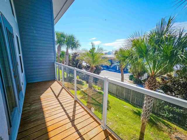 a view of balcony with wooden floor and fence