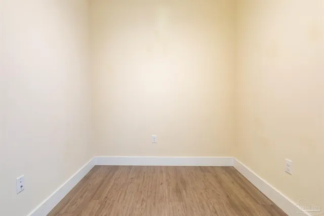 a bathroom with a granite countertop toilet a sink and a mirror
