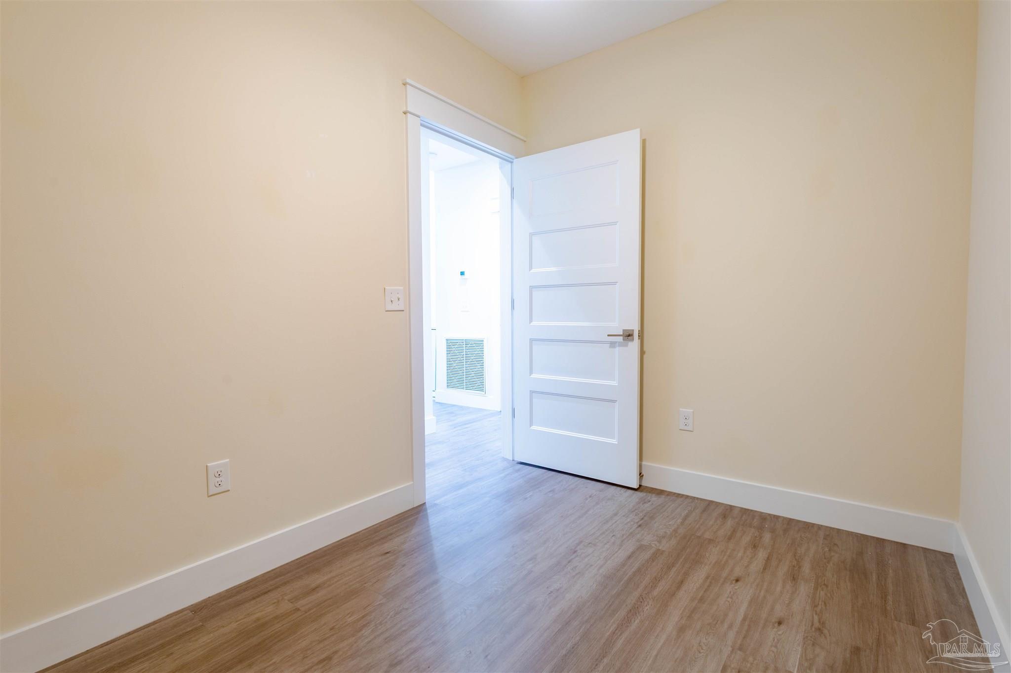 340 Bluefish Drive, Unit 206 Fort Walton Beach, FL 32548 - Photo 35 of 43 a view of an empty room with wooden floor
