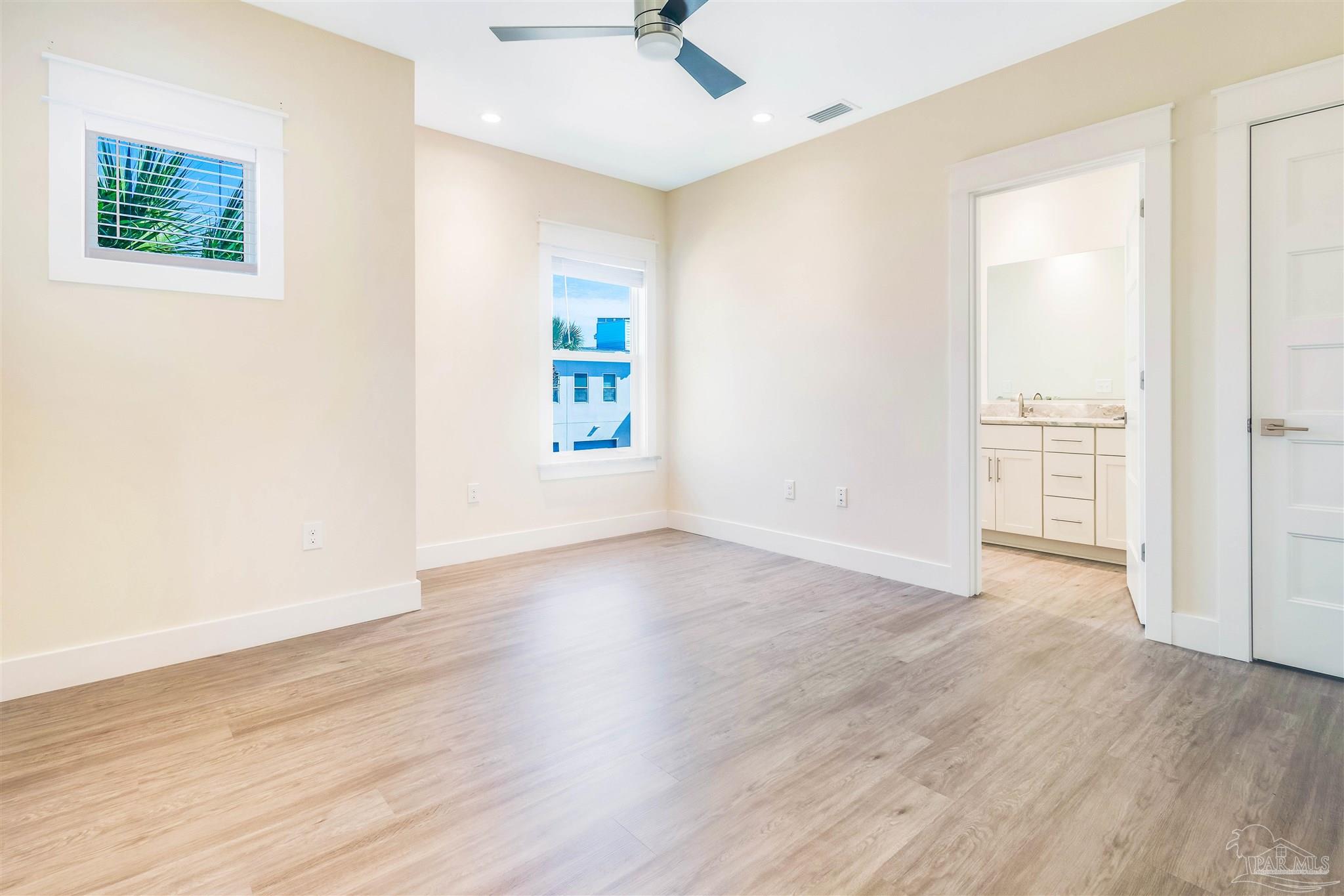 340 Bluefish Drive, Unit 206 Fort Walton Beach, FL 32548 - Photo 38 of 43 an empty room with wooden floor and windows