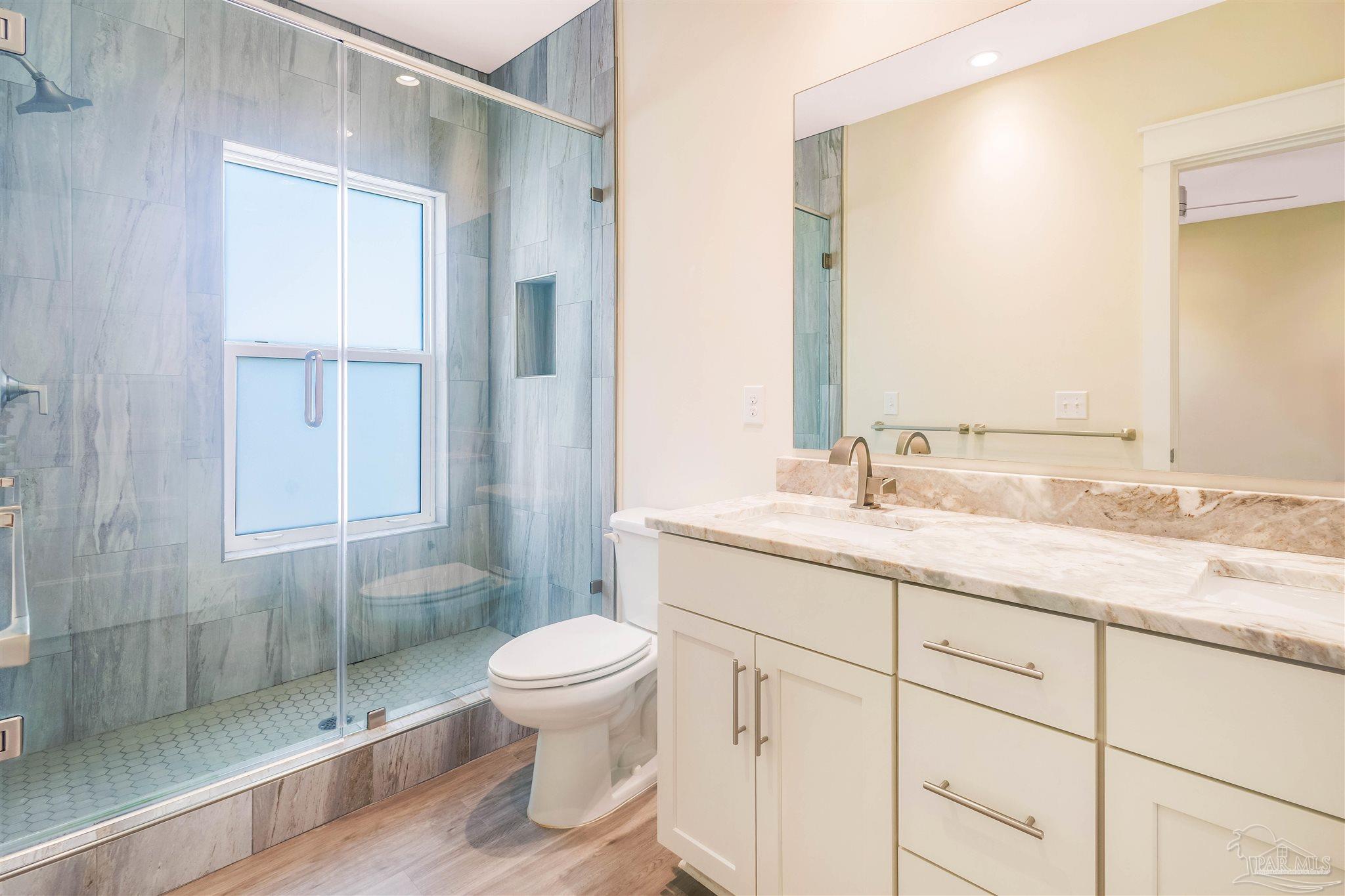 340 Bluefish Drive, Unit 206 Fort Walton Beach, FL 32548 - Photo 40 of 43 a bathroom with a granite countertop sink toilet and shower