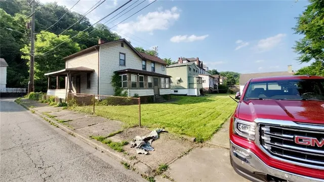 a front view of house with yard and outdoor seating