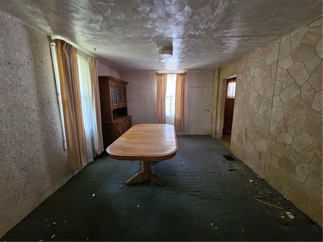 a room with pool table and window