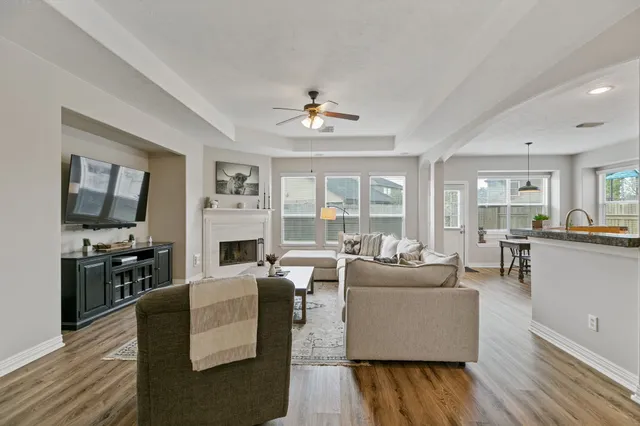 a living room with fireplace furniture and a flat screen tv
