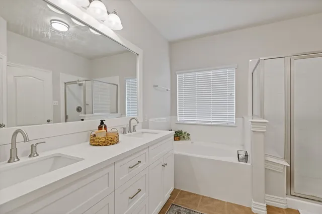 a bathroom with a tub a sink and mirror