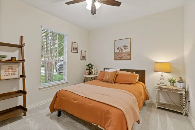 a bedroom with a bed and a window