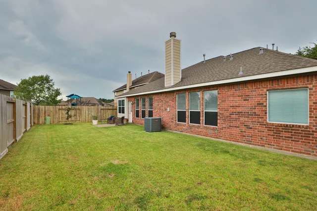 a front view of a house with a garden and yard